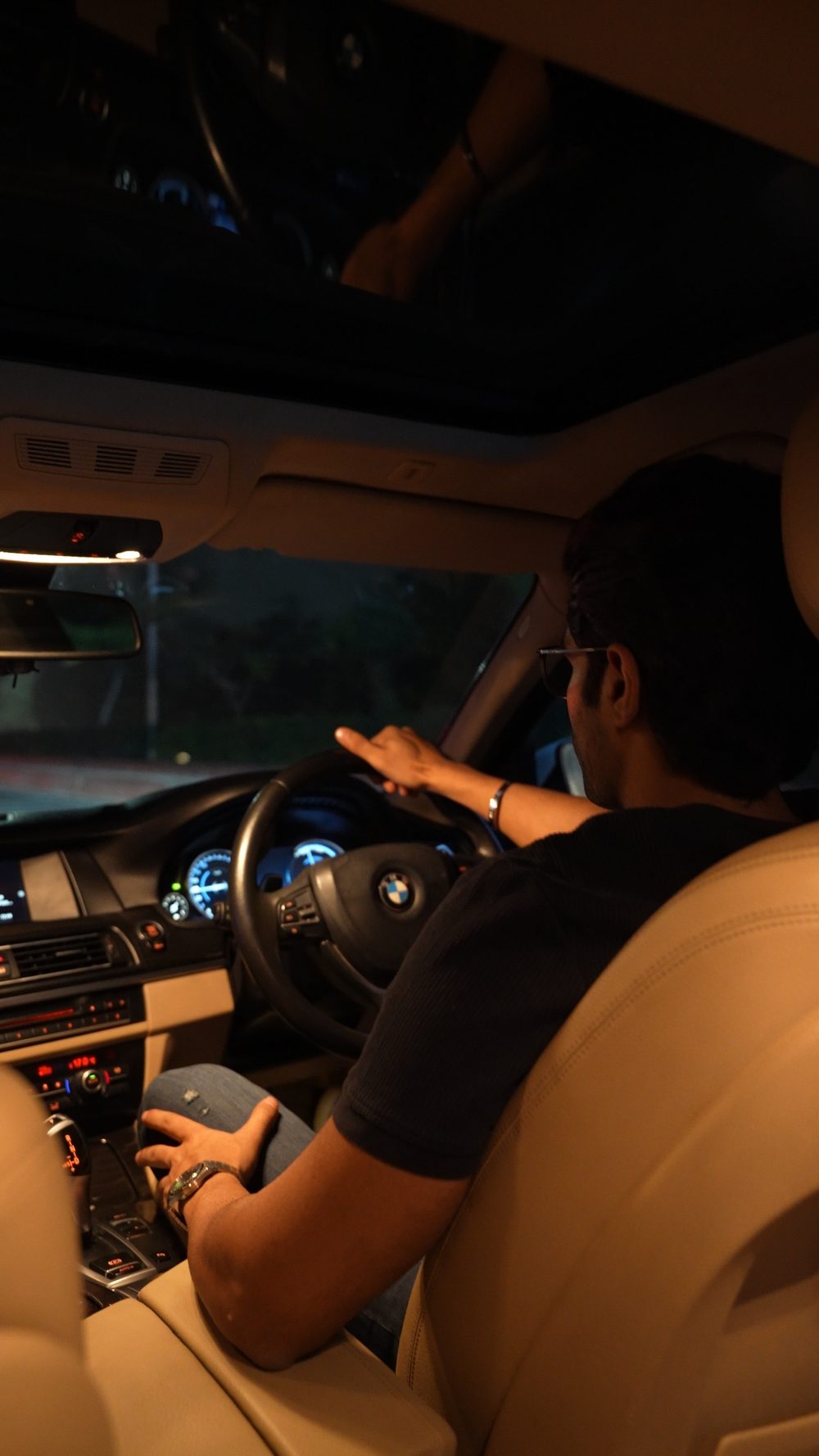 Driver seated inside a BMW at night